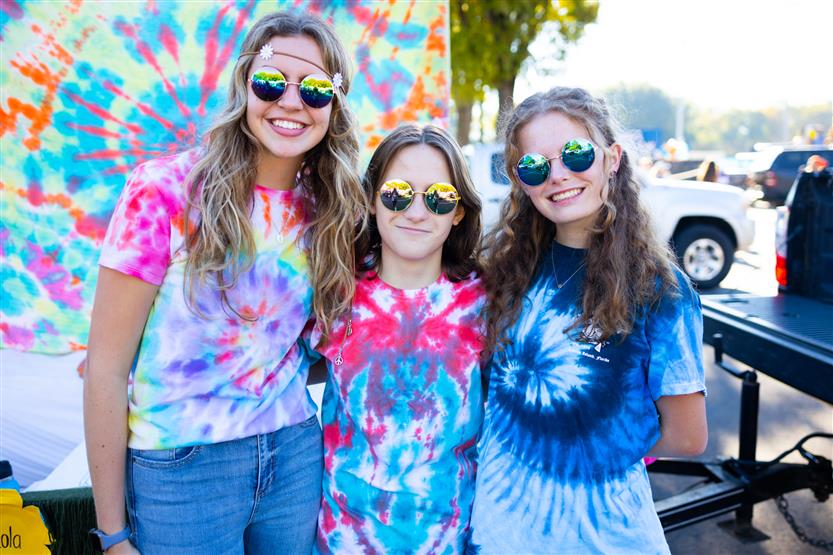 Students ride on a homecoming parade float